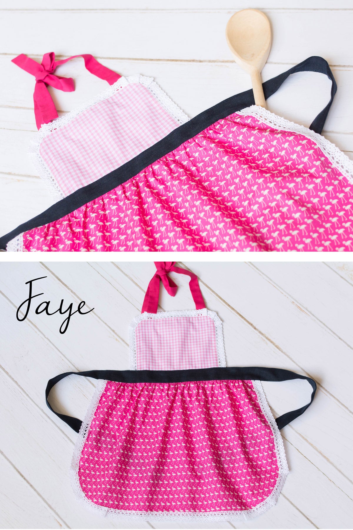 Pink apron for toddler with navytrim on a white wooden surface, branded 'Faye'.