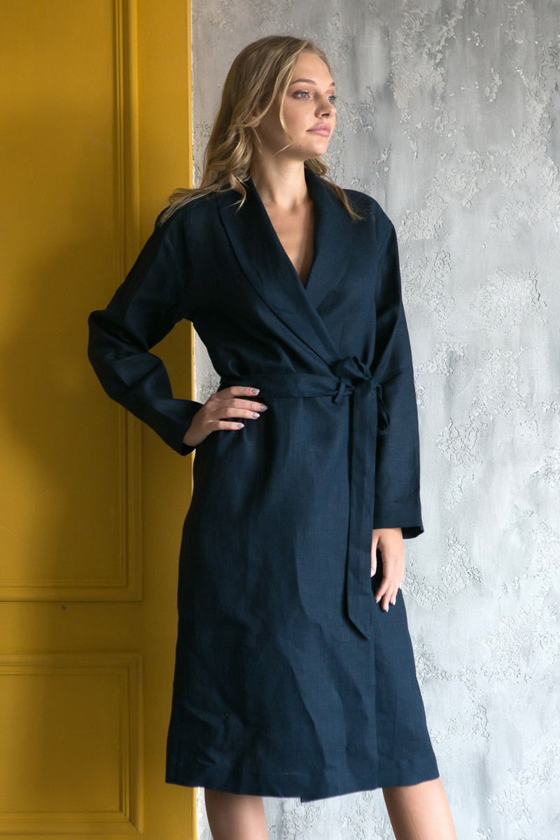 Woman wearing a navy blue linen robe in a spa salon.