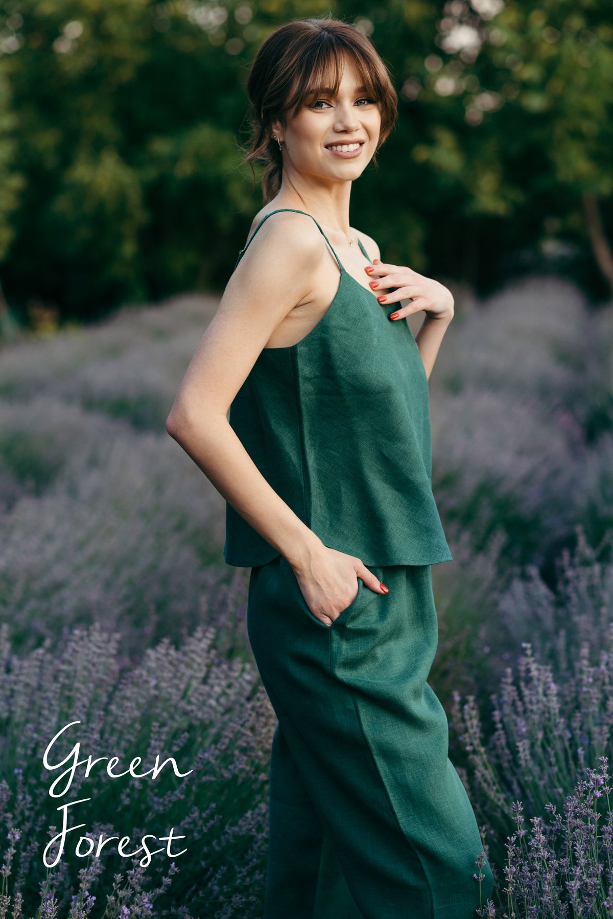 Woman in a green pyjamas cami and pants standing in a lavender field