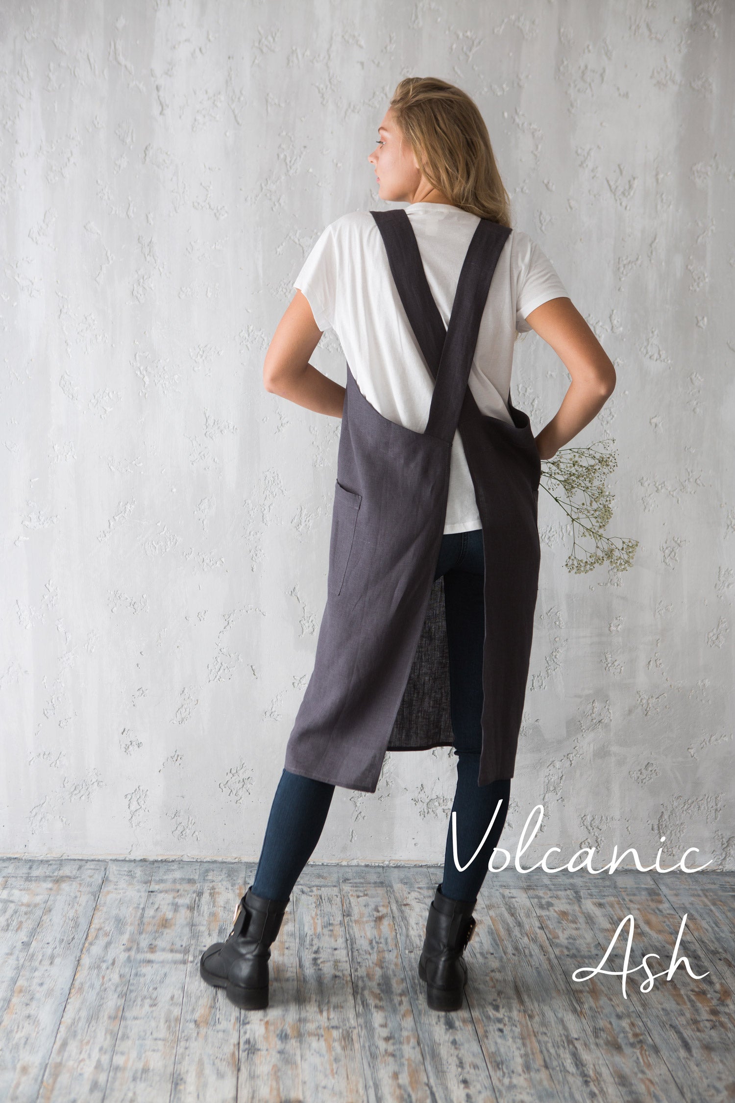 Back view of charcoal grey linen cross-back apron with wide straps.