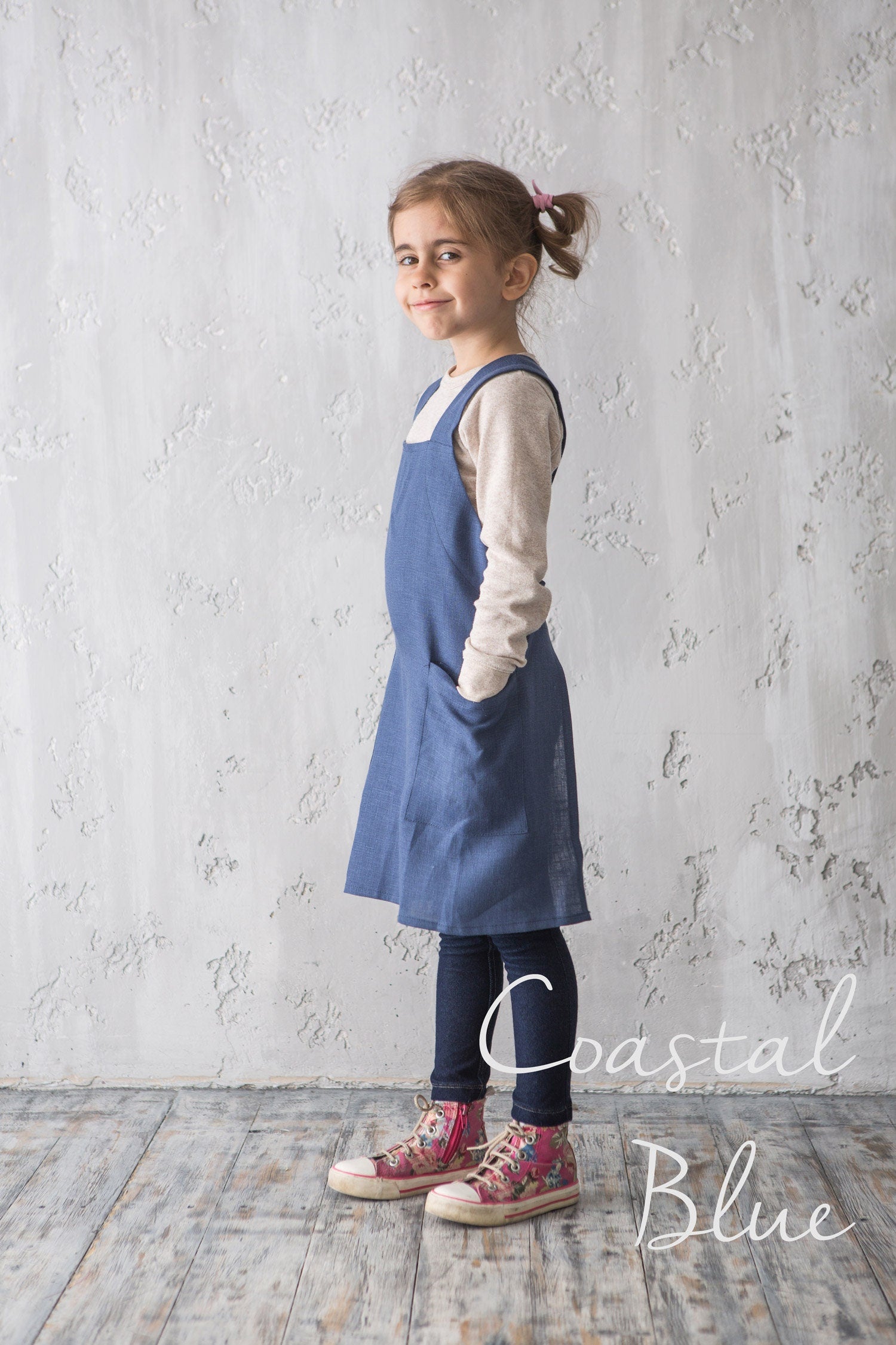 Girl in blue linen kids pinafore apron