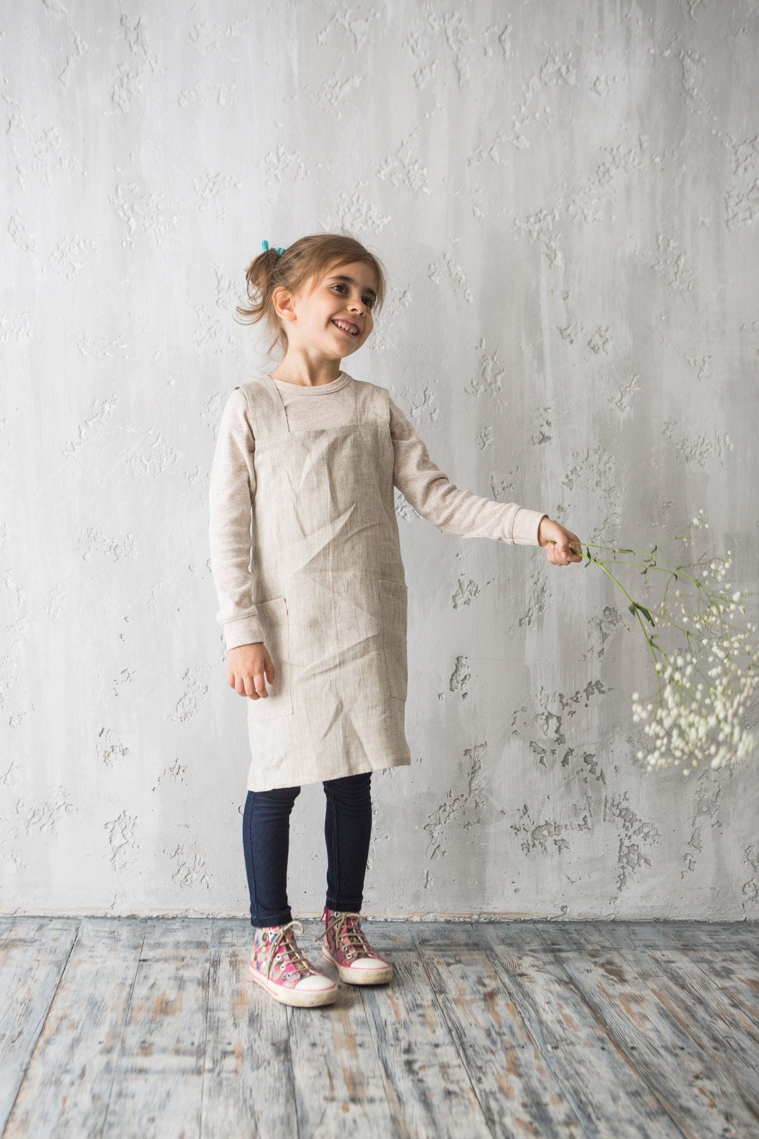 Girl wearing natural linen kids pinafore apron