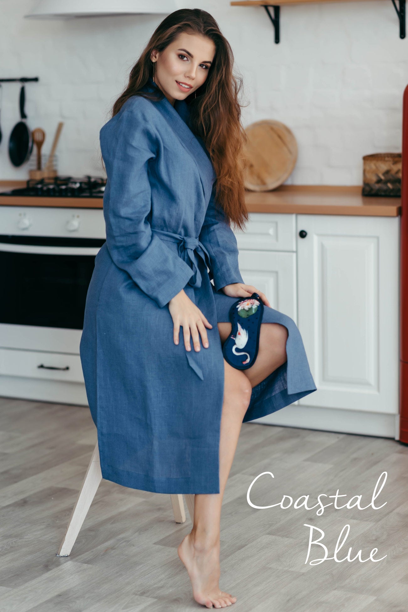Woman wearing a coastal blue women’s linen bathrobe, relaxed loungewear robe.