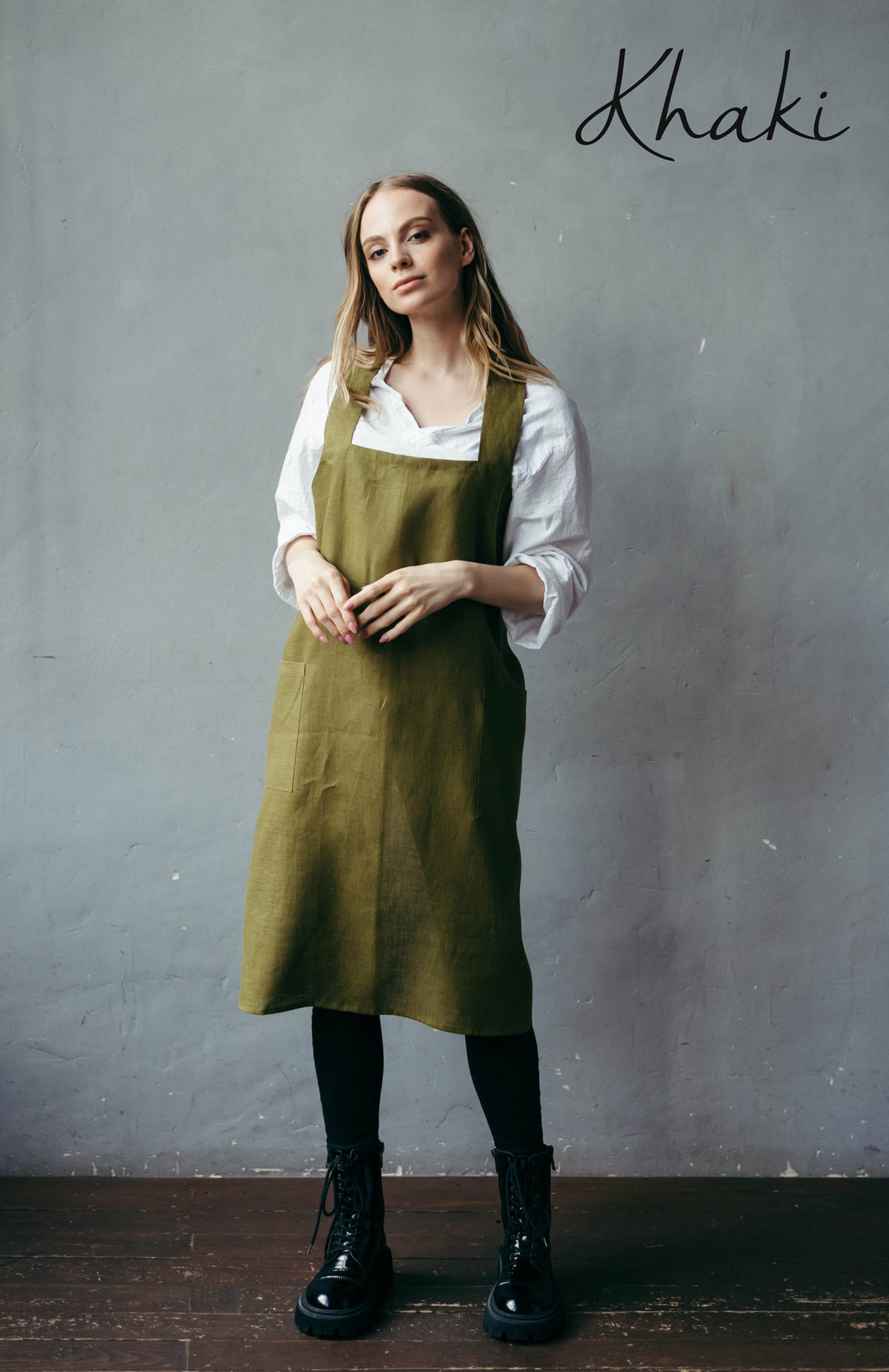 Woman in khaki green linen pinafore apron