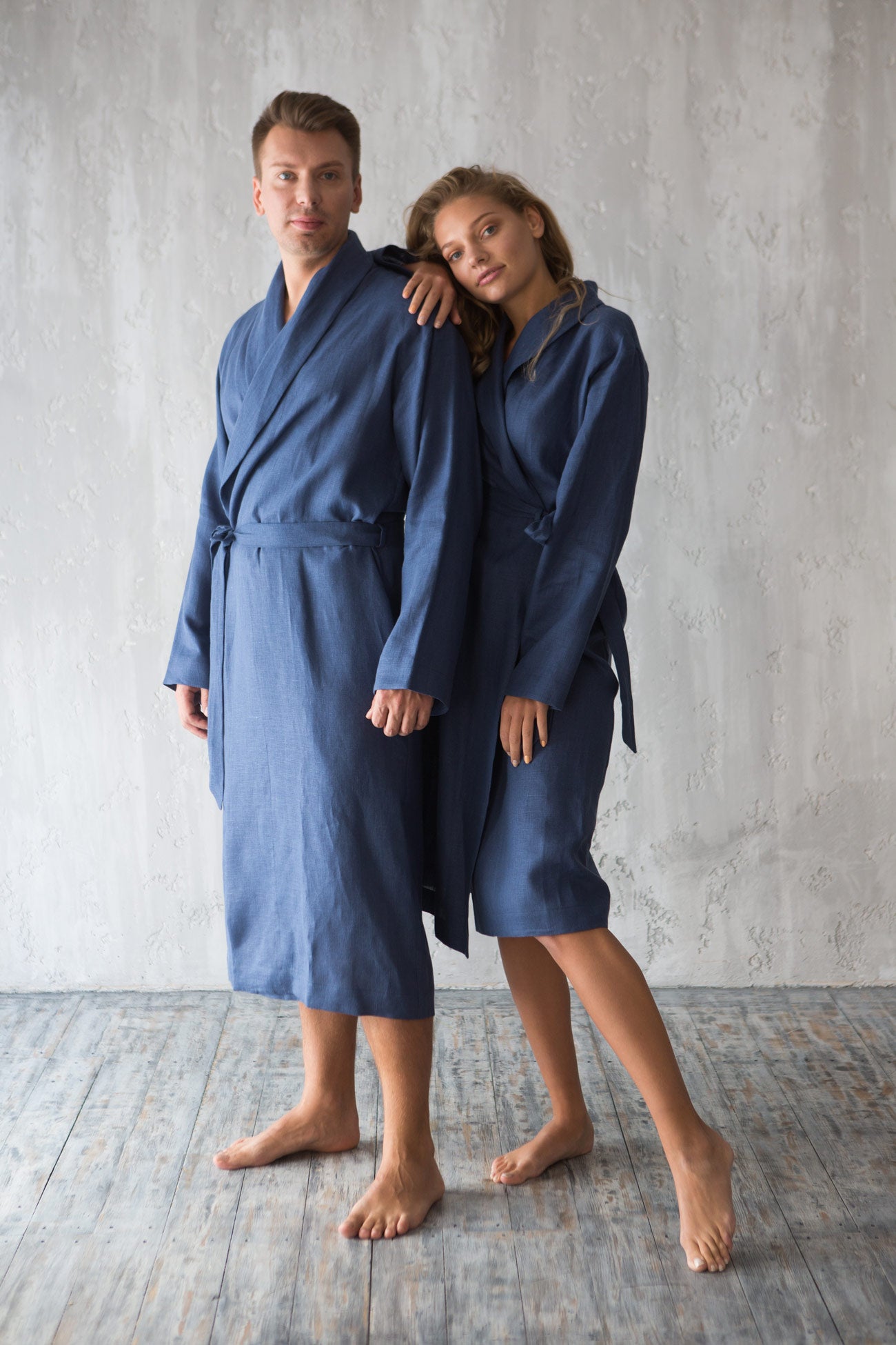 Couple wearing matching coastal blue linen bathrobes - men’s and women’s European linen robes.