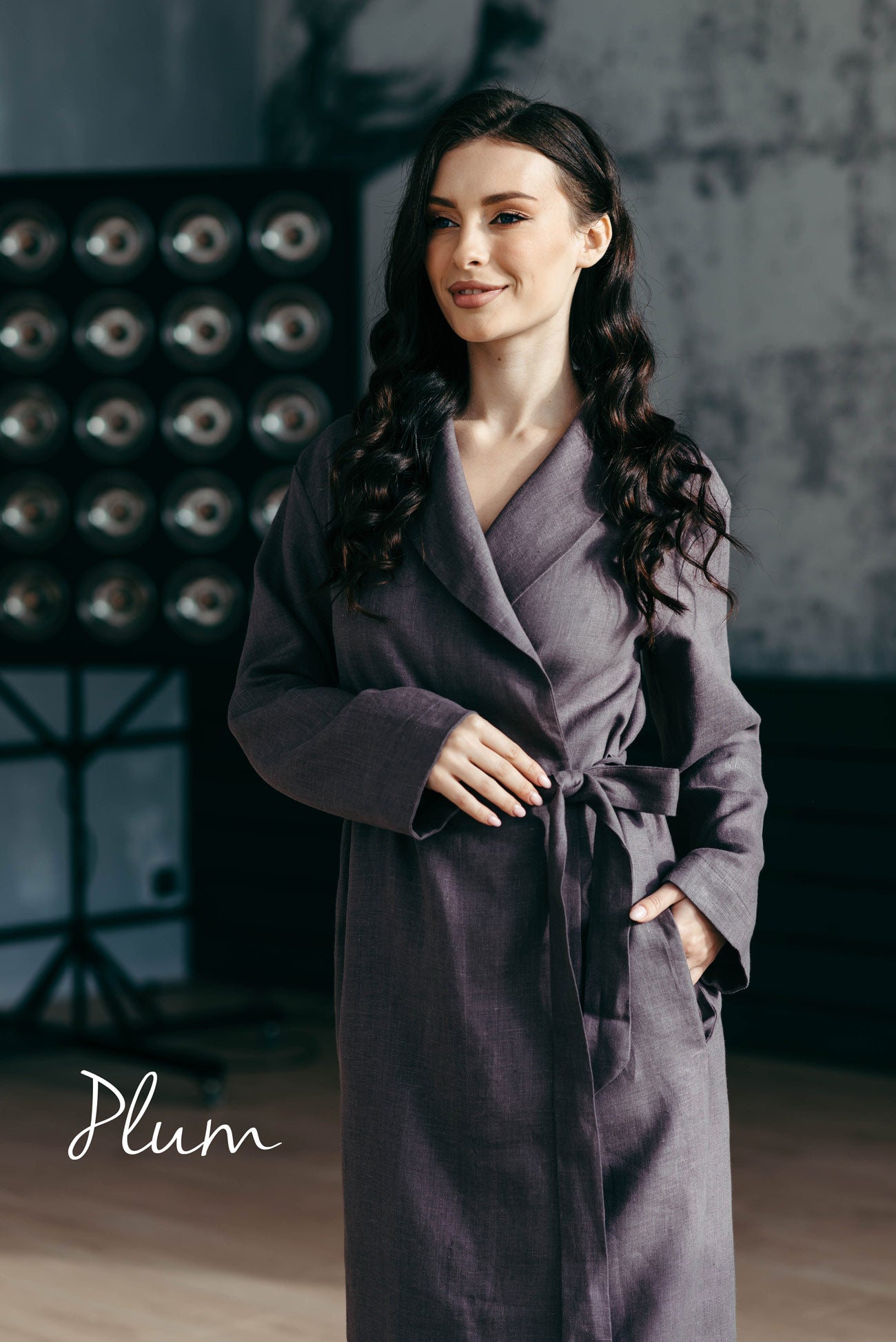 Woman wearing a plum-colored spa dressing gown in a hotel.