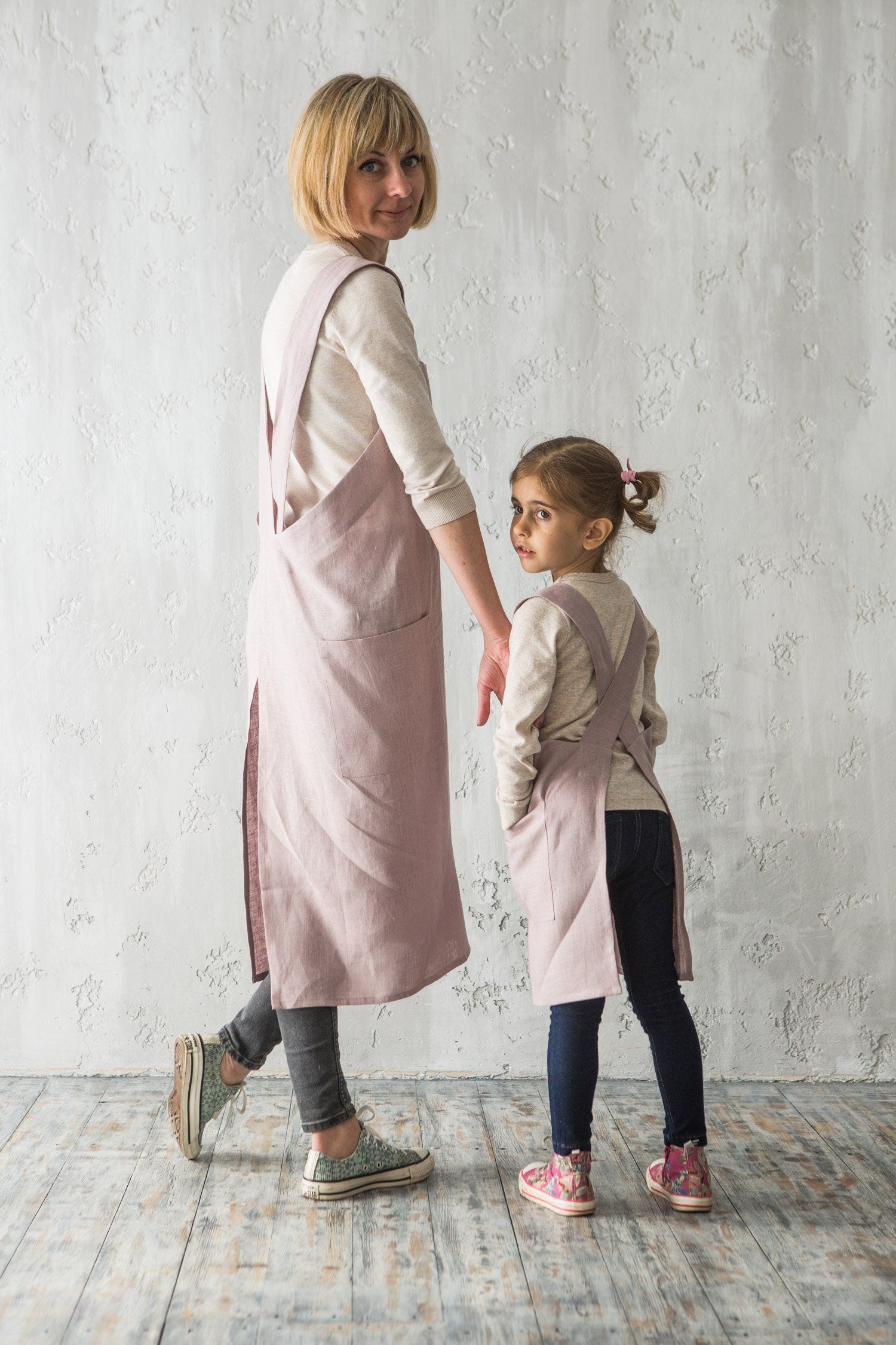 Mother and daughter in matching pink heather linen pinafores
