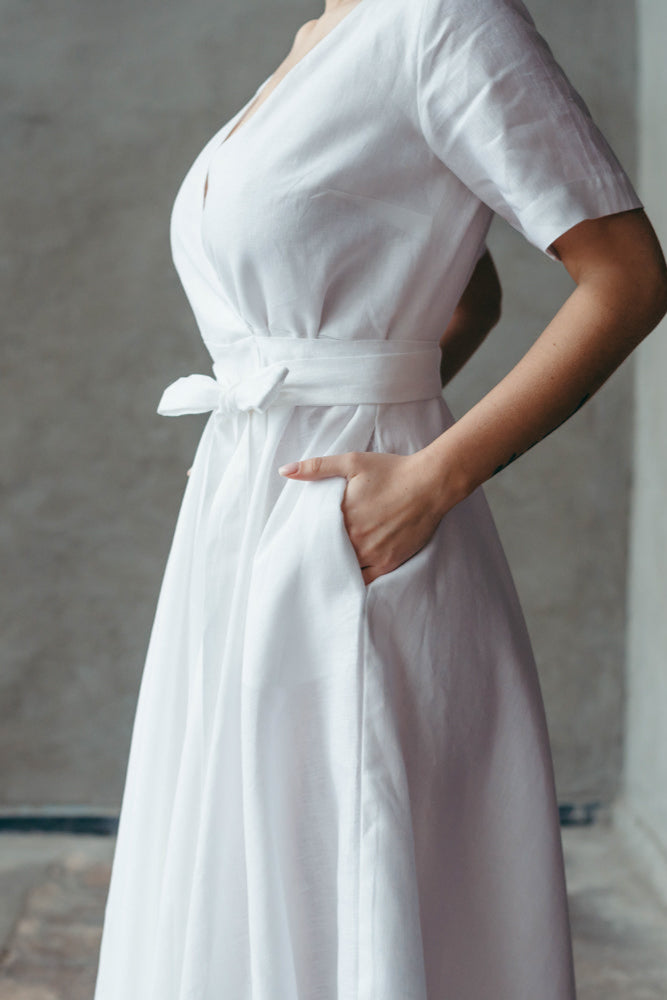 A bride wearing a white linen wap dress at a destination wedding.