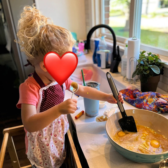 Customer wearing Kids’ Personalised Aprons | Reds Prints, Polka Dots and Florals
