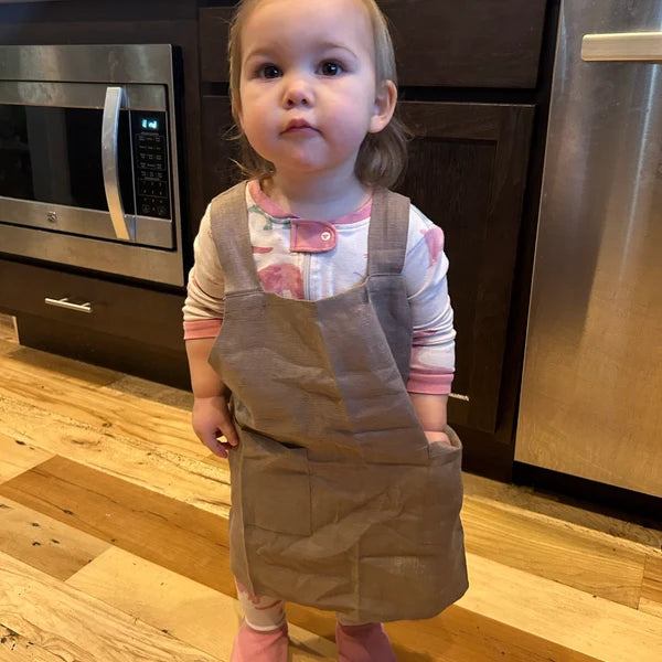 Customer wearing Linen Smock Apron for Kids | Easy Cross-Back Design