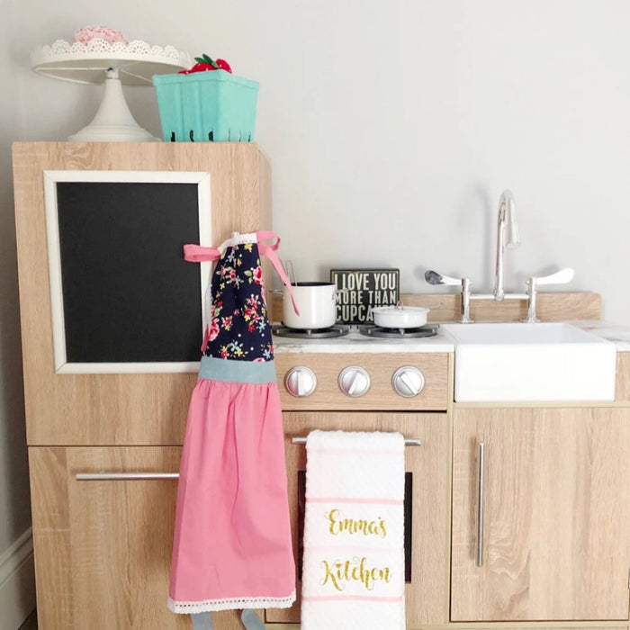 Customer wearing Kids’ Personalised Aprons | Pink Prints, Stripes and Florals