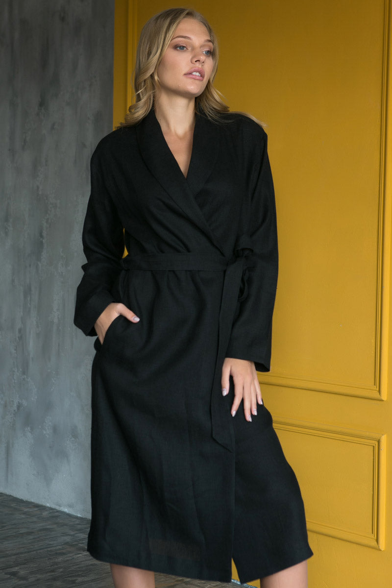 Woman in black linen bathrobe showing back view, wrap-style women’s robe.