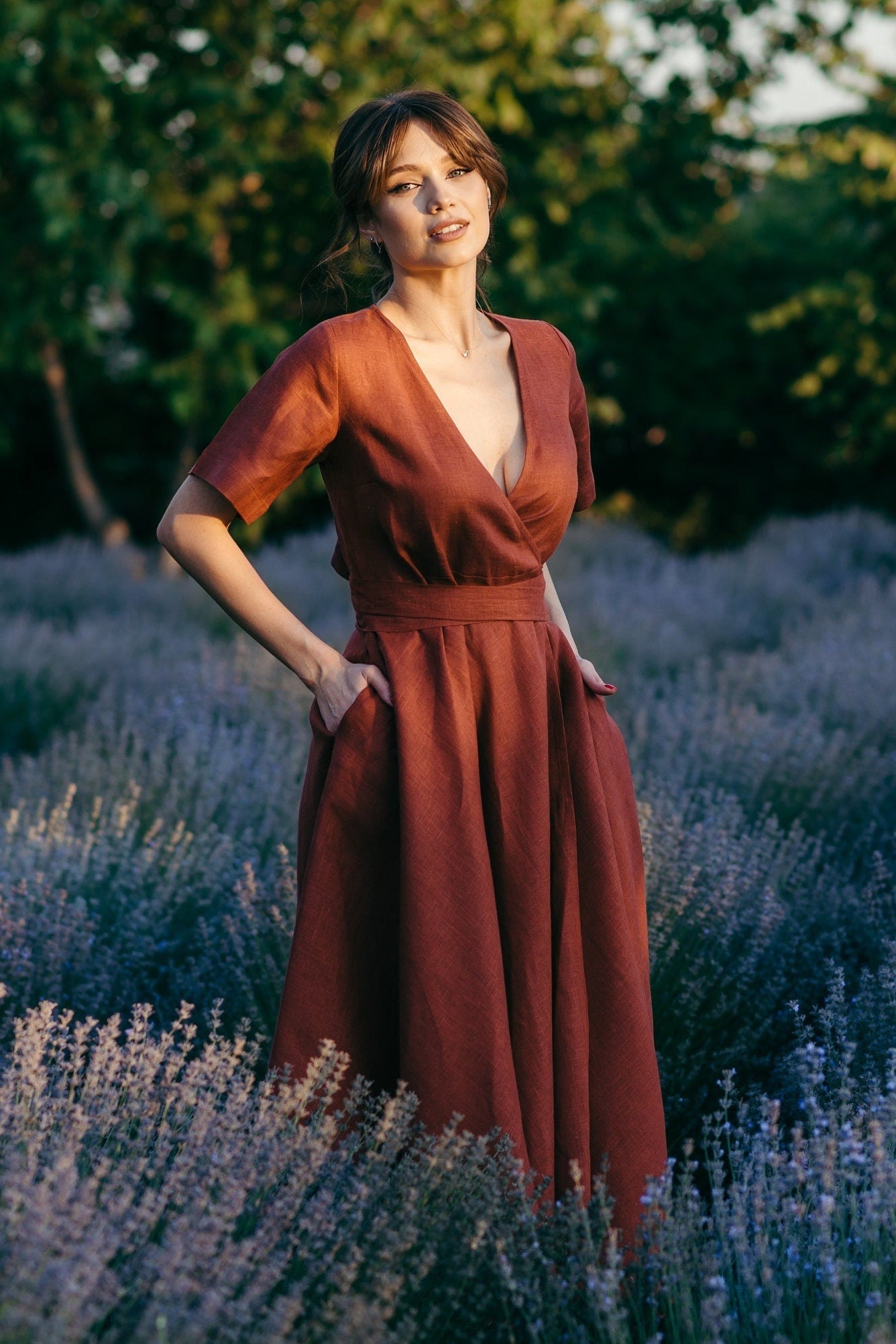 Woman in a rust natural linen dress standing in a lavender field