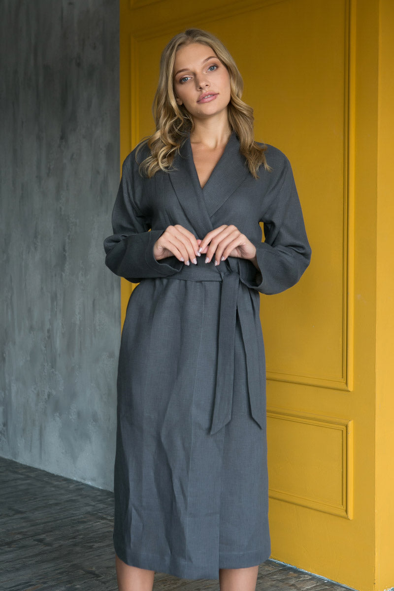 Woman wearing a grey linen women’s dressing gown, relaxed long-sleeve robe.