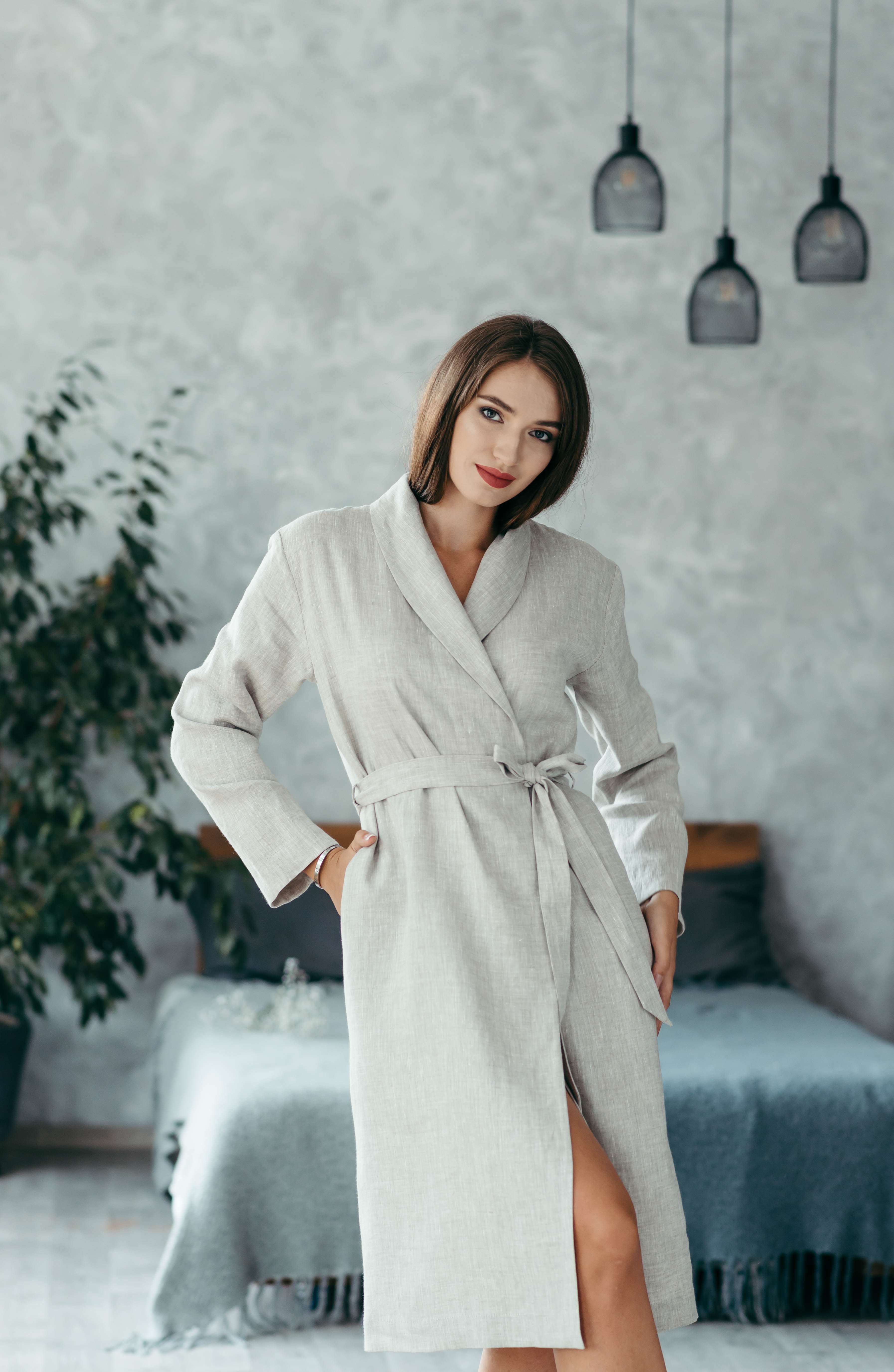 Woman wearing a natural linen women’s bathrobe, breathable wrap-style robe.